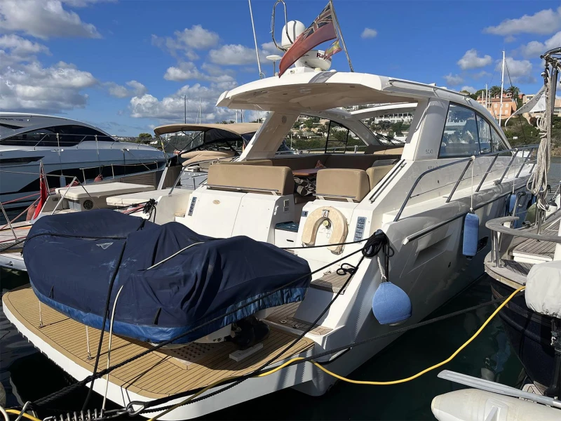2012 Sealine SC47 yacht docked at marina, featuring sleek design and spacious deck.