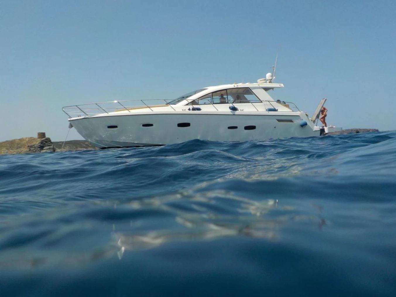 2012 Sealine SC47 yacht cruising on open water under clear skies.