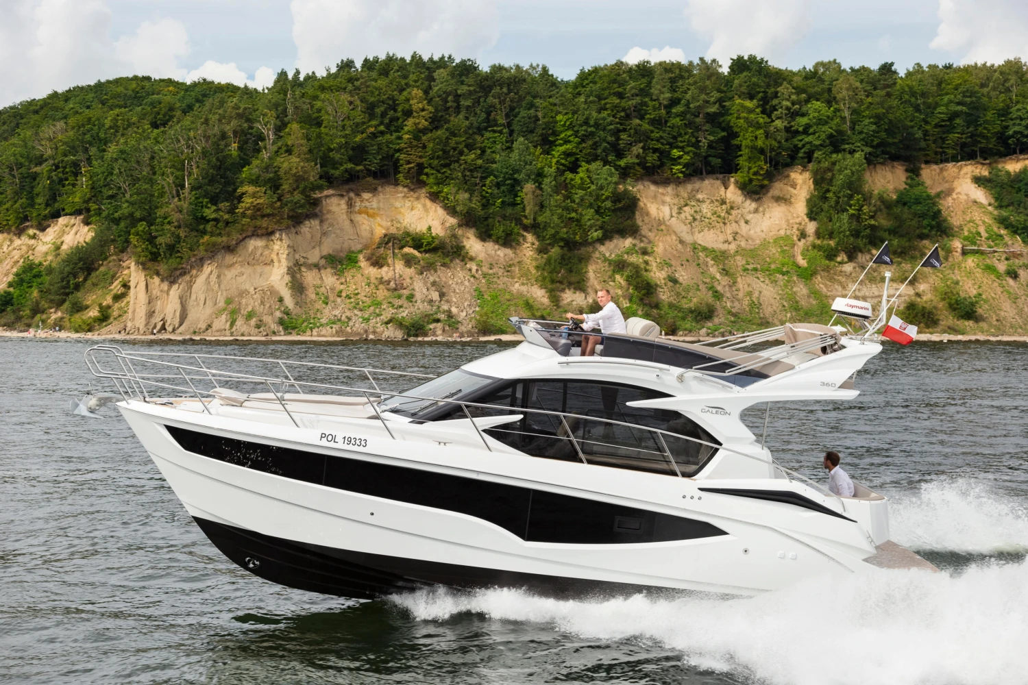 2025 Galeon 360 Fly yacht cruising on a scenic river with lush green cliffs.