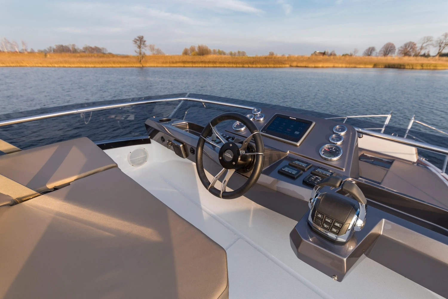 Helm of 2025 Galeon 360 Fly yacht on calm water.
