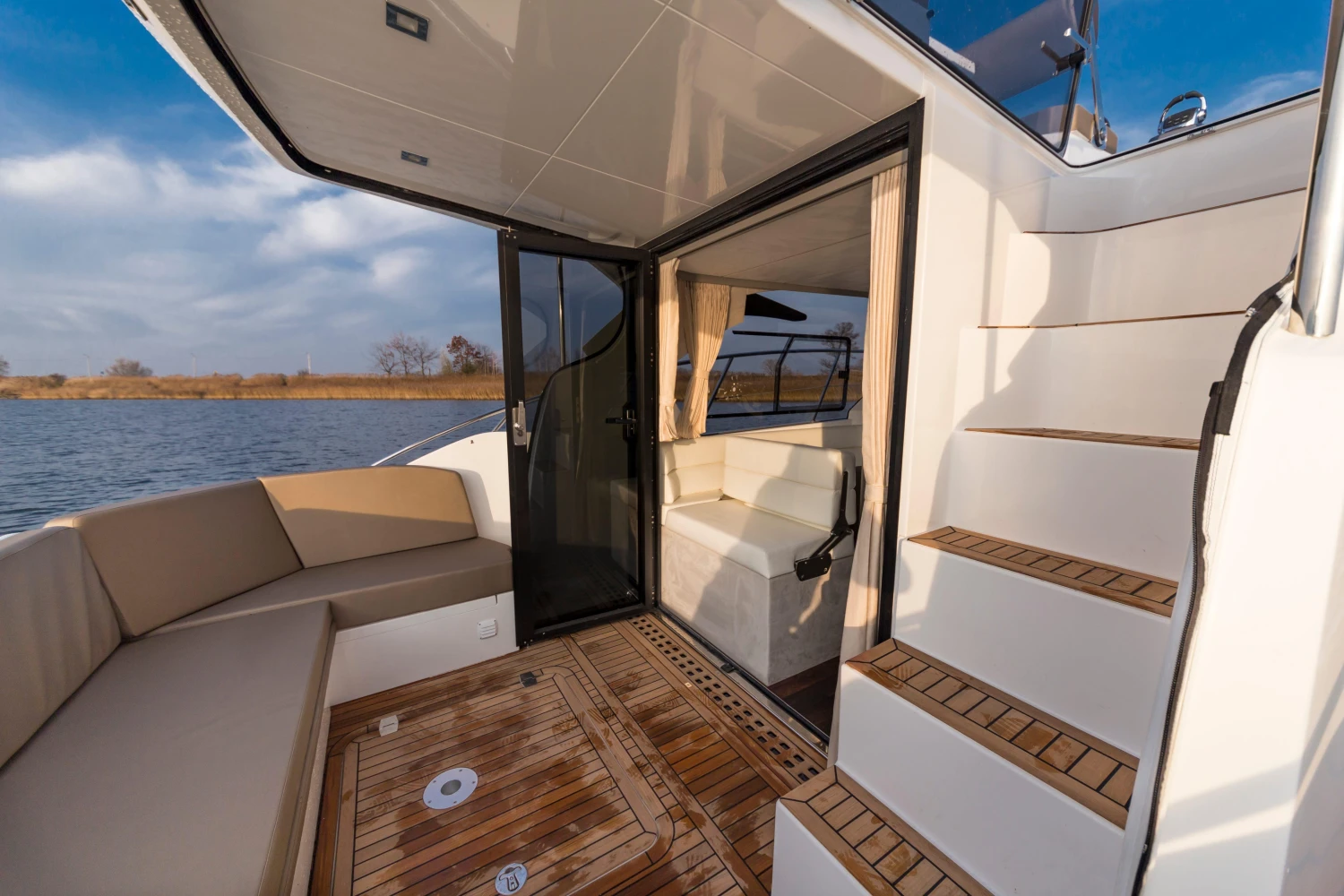 2025 Galeon 360 Fly yacht with elegant deck and seating area by the water.