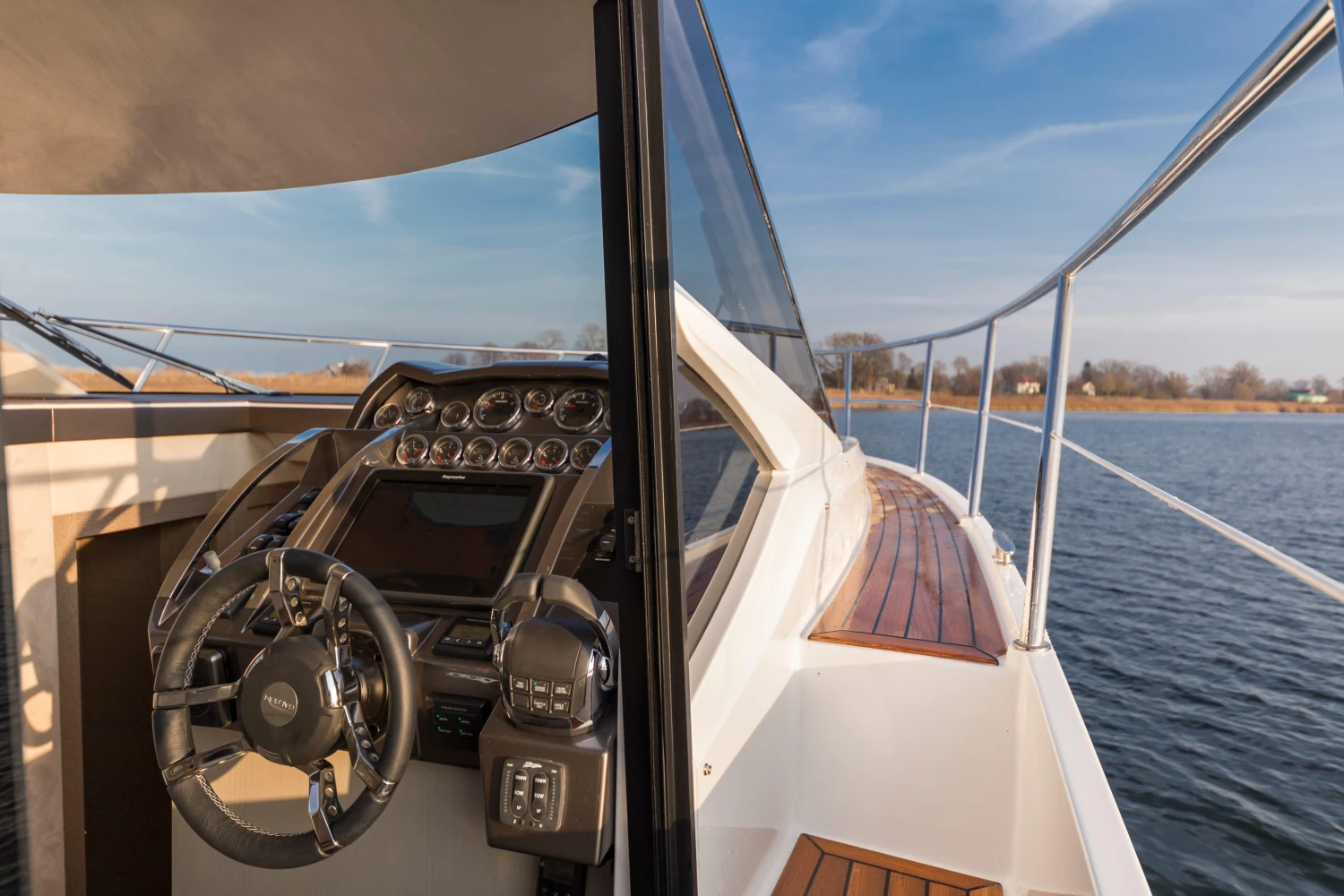 2025 Galeon 360 Fly yacht helm and deck view on calm water.
