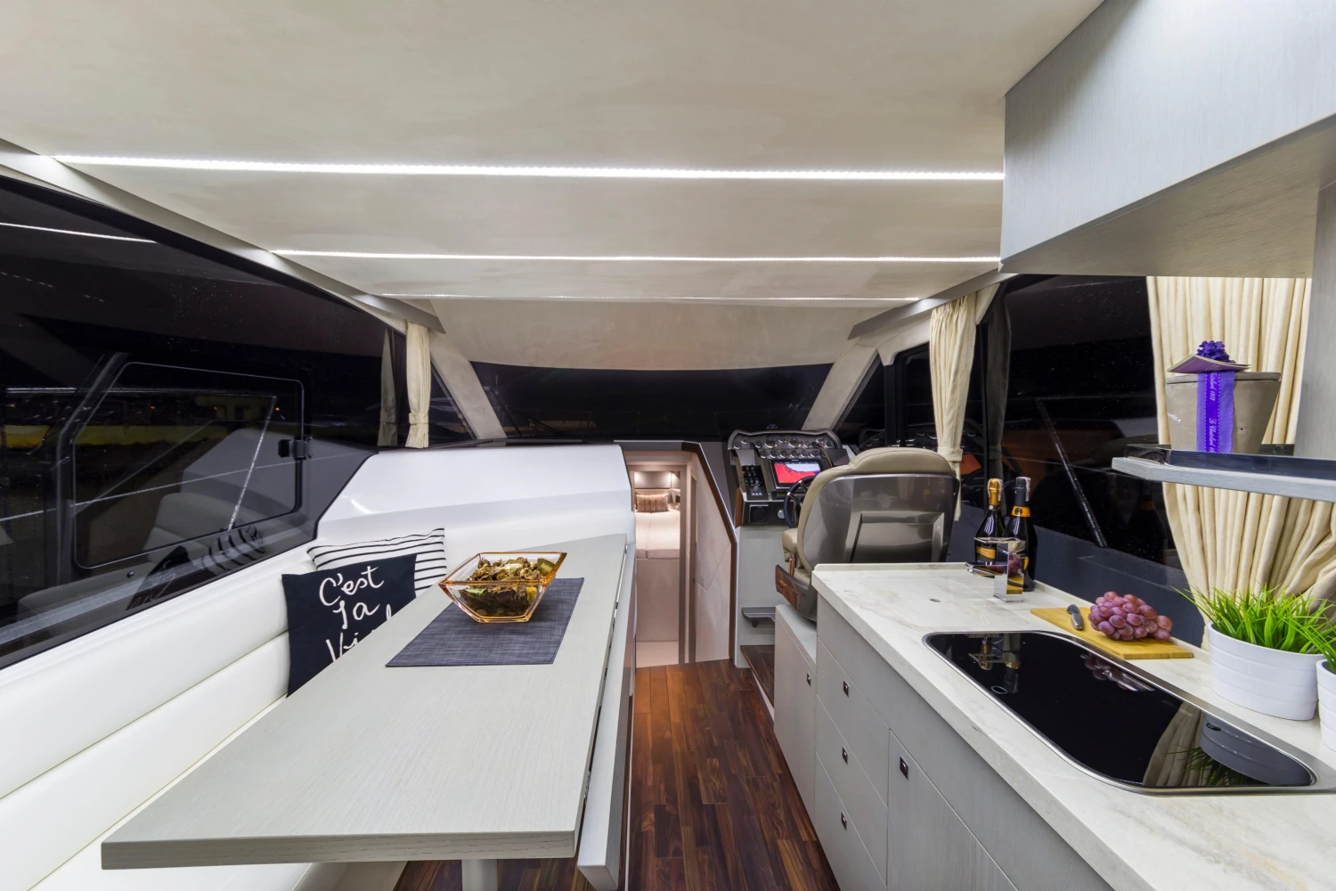 Luxurious interior of 2025 Galeon 360 Fly yacht with modern dining and kitchen area.