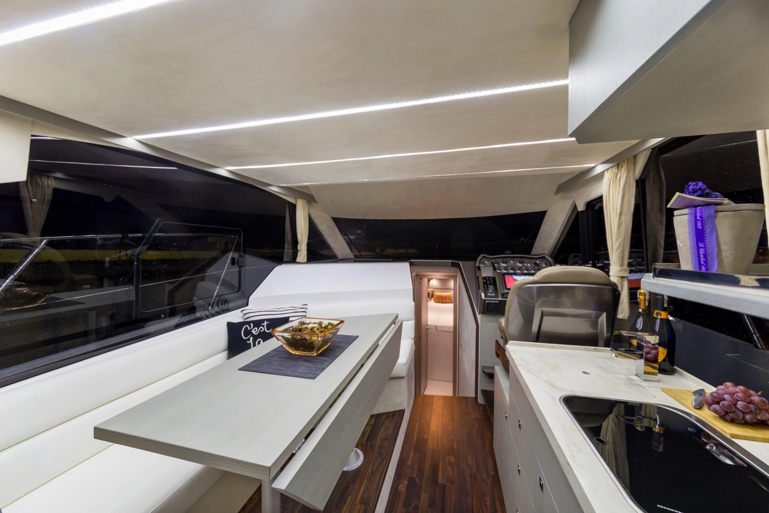 Luxurious interior of 2025 Galeon 360 Fly yacht with modern seating and dining area.