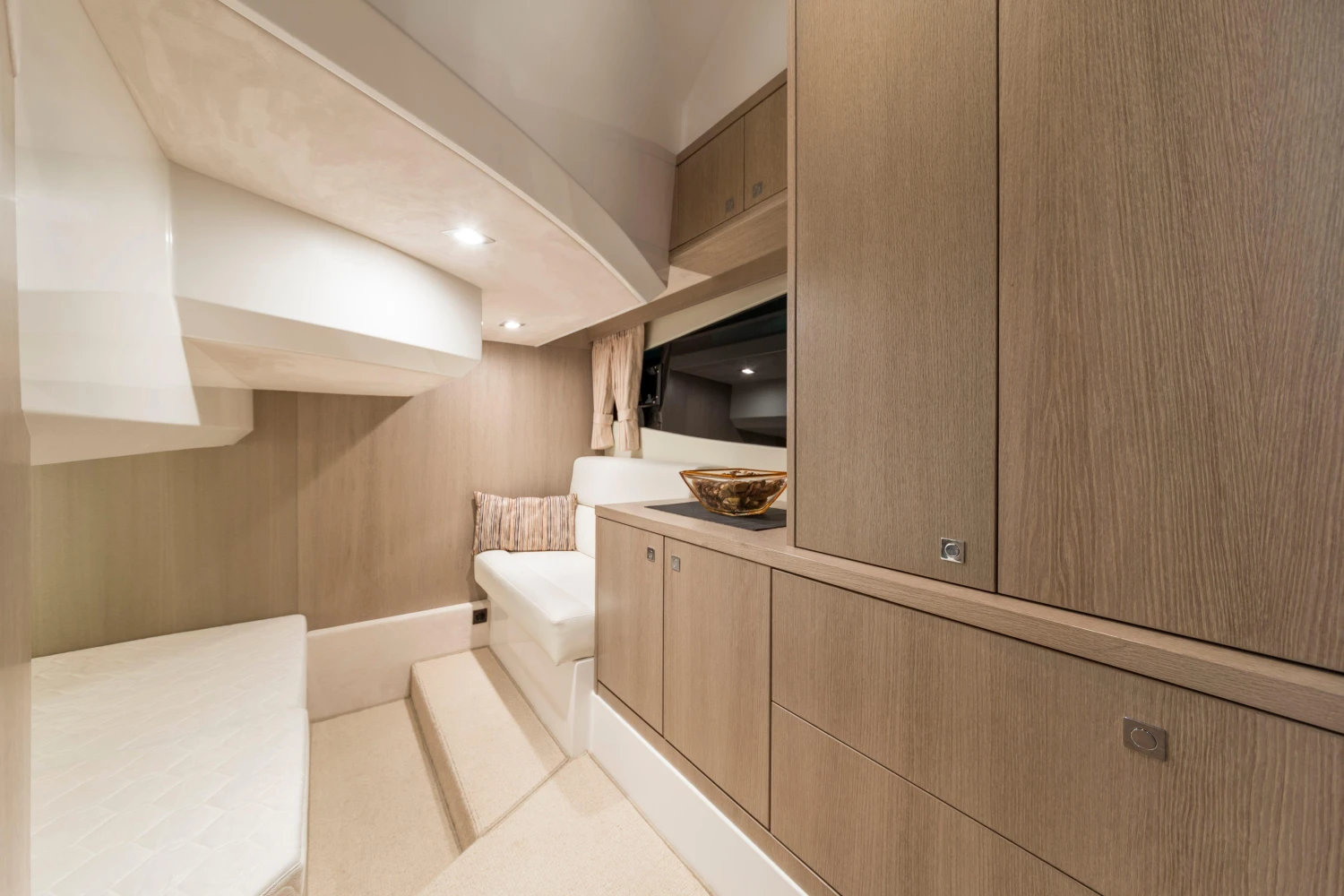 Luxurious interior of 2025 Galeon 360 Fly yacht with modern wood cabinetry and seating.