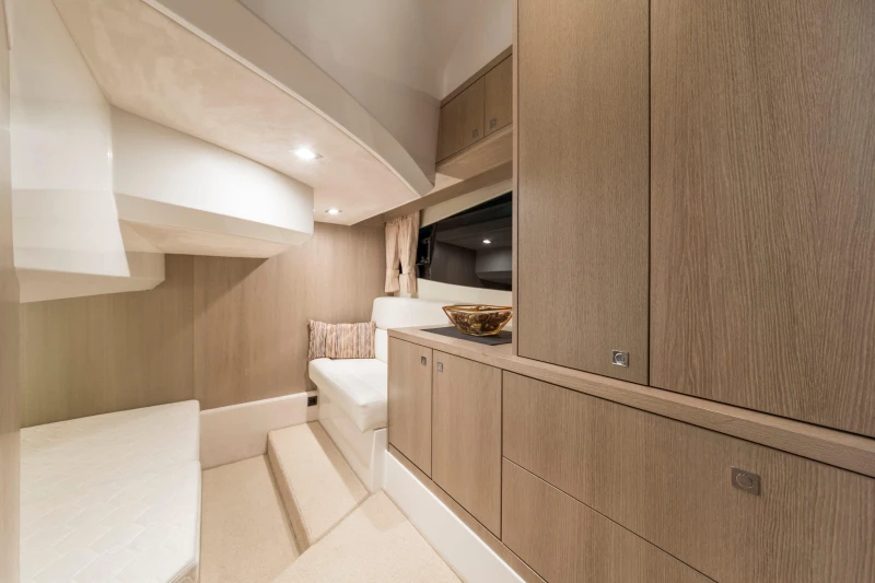 Luxurious interior of 2025 Galeon 360 Fly yacht with modern wood cabinetry and seating.