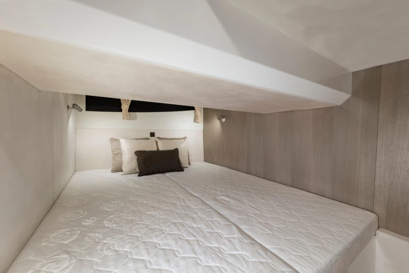 Interior cabin of 2025 Galeon 360 Fly yacht with cozy bedding.