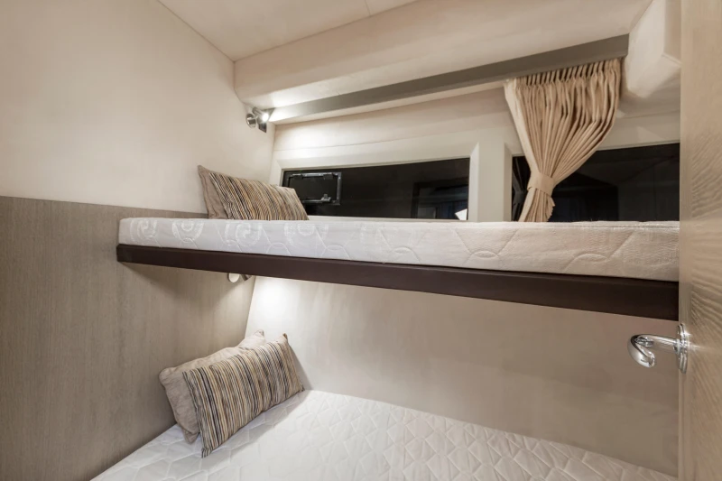 Bunk beds in 2025 Galeon 360 Fly yacht cabin, featuring modern design and cozy bedding.
