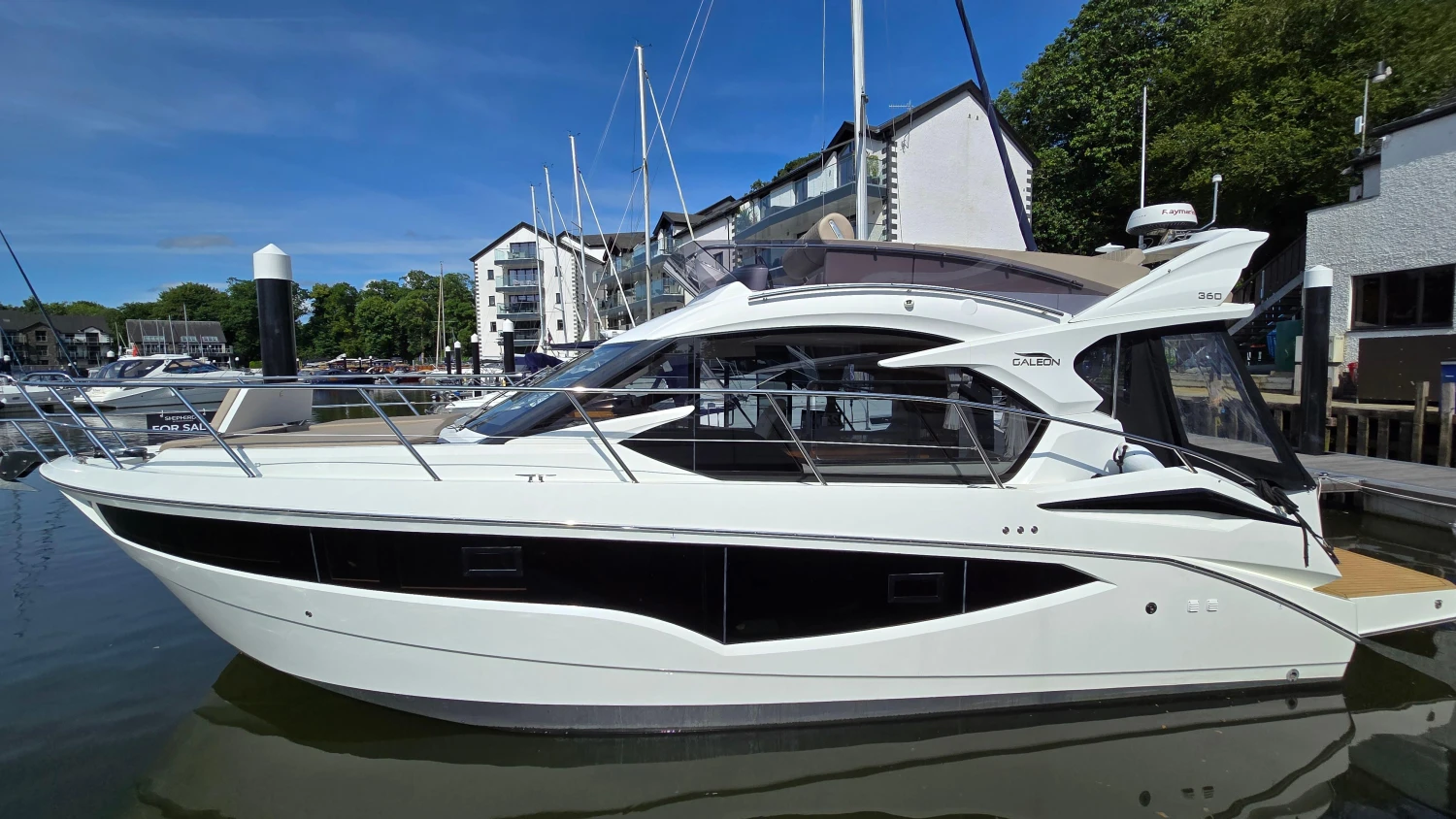 2025 Galeon 360 Fly yacht docked at a marina, showcasing sleek design and modern features.