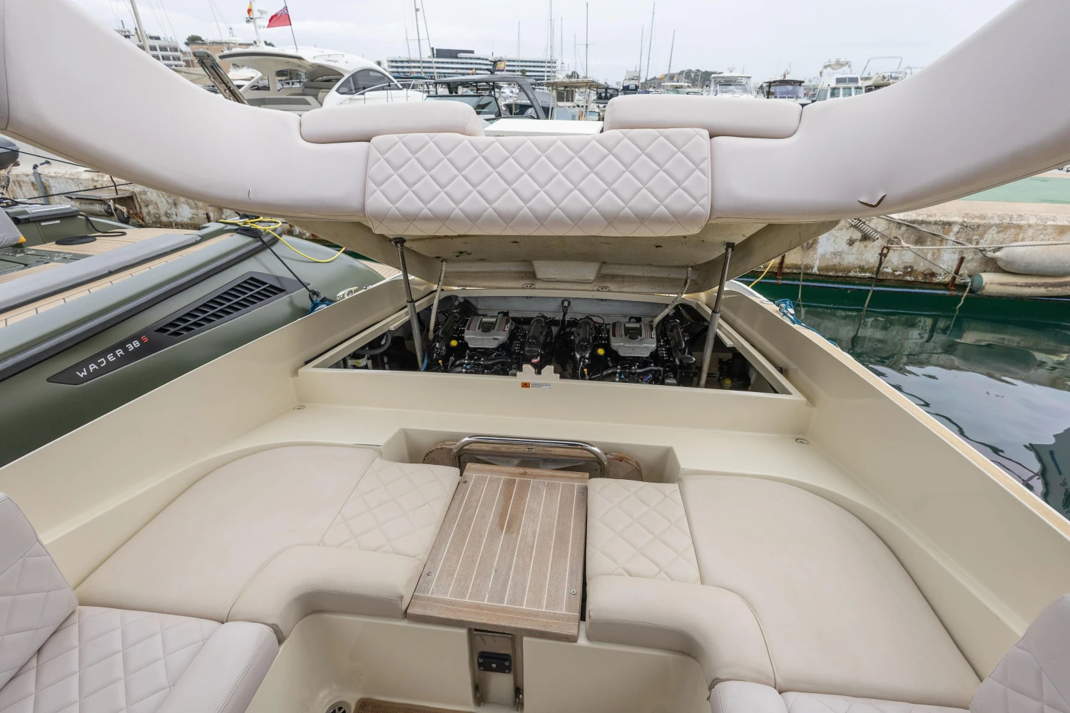 2013 Chris-Craft Launch 32 boat interior with open engine compartment, docked at marina.