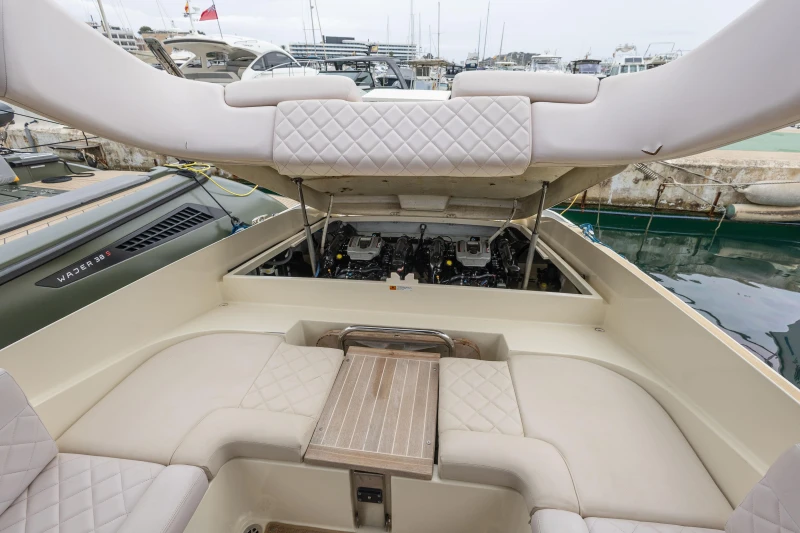 2013 Chris-Craft Launch 32 boat interior with open engine compartment, docked at marina.