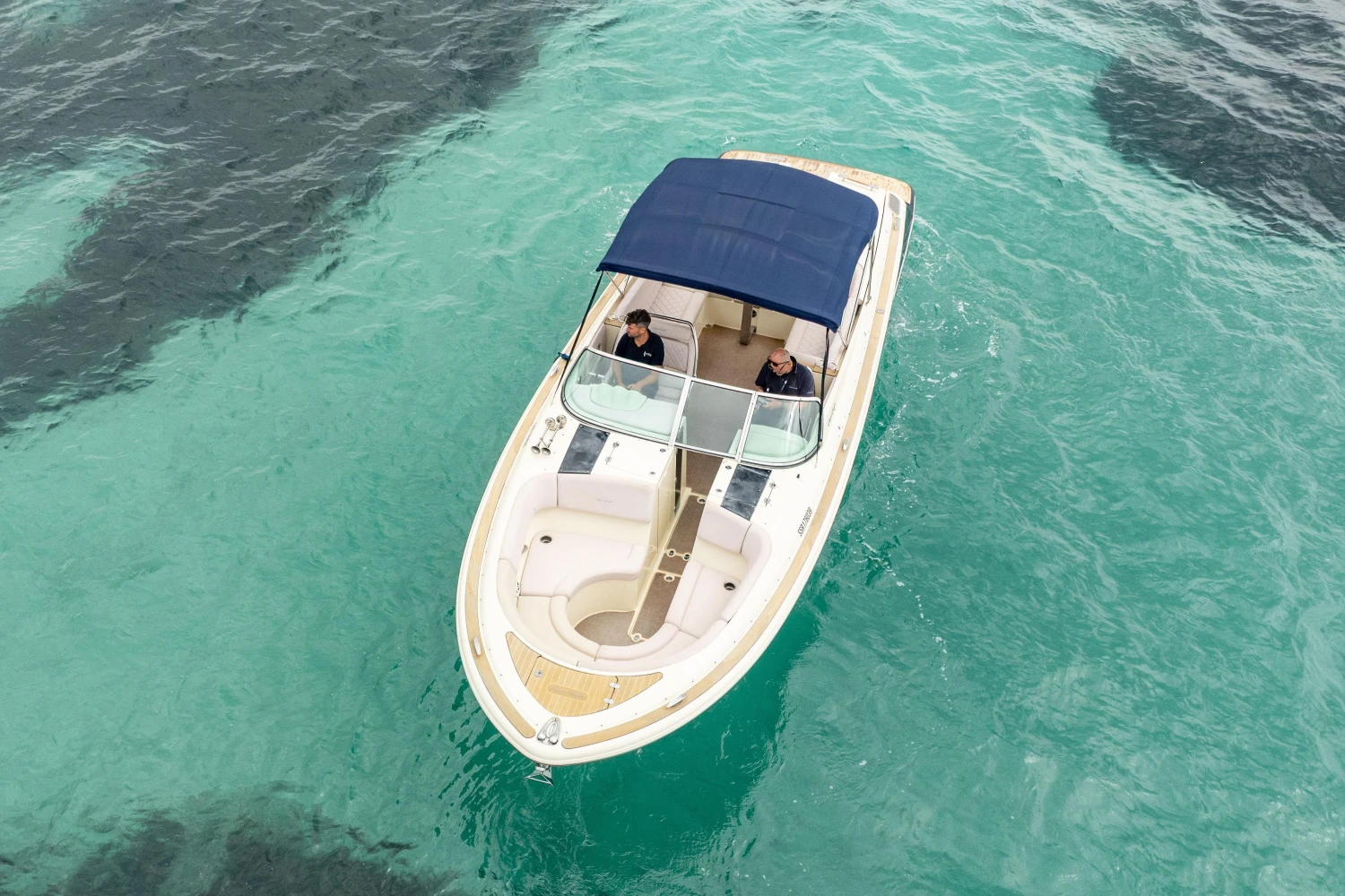 2013 Chris-Craft Launch 32 boat on clear turquoise water, aerial view.