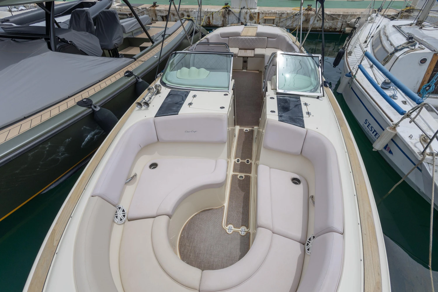 2013 Chris-Craft Launch 32 boat with spacious seating, docked at a marina.