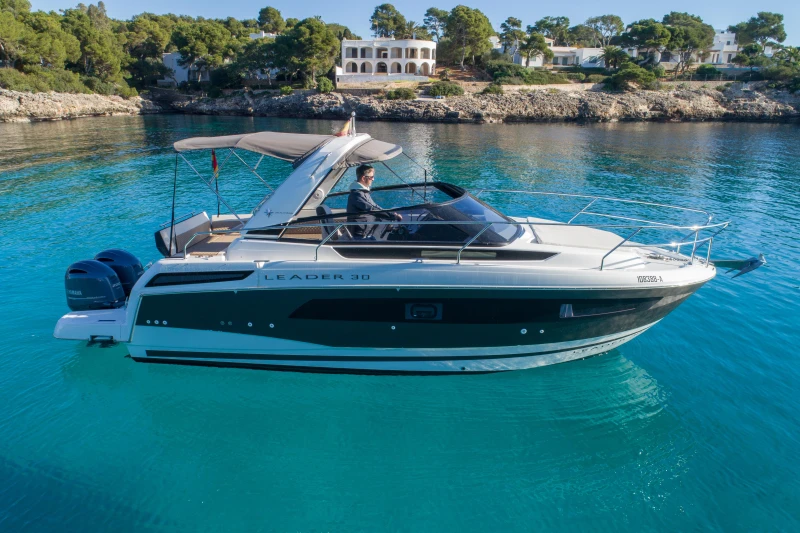 2018 Jeanneau Leader 30 boat on clear blue water, scenic coastal background.