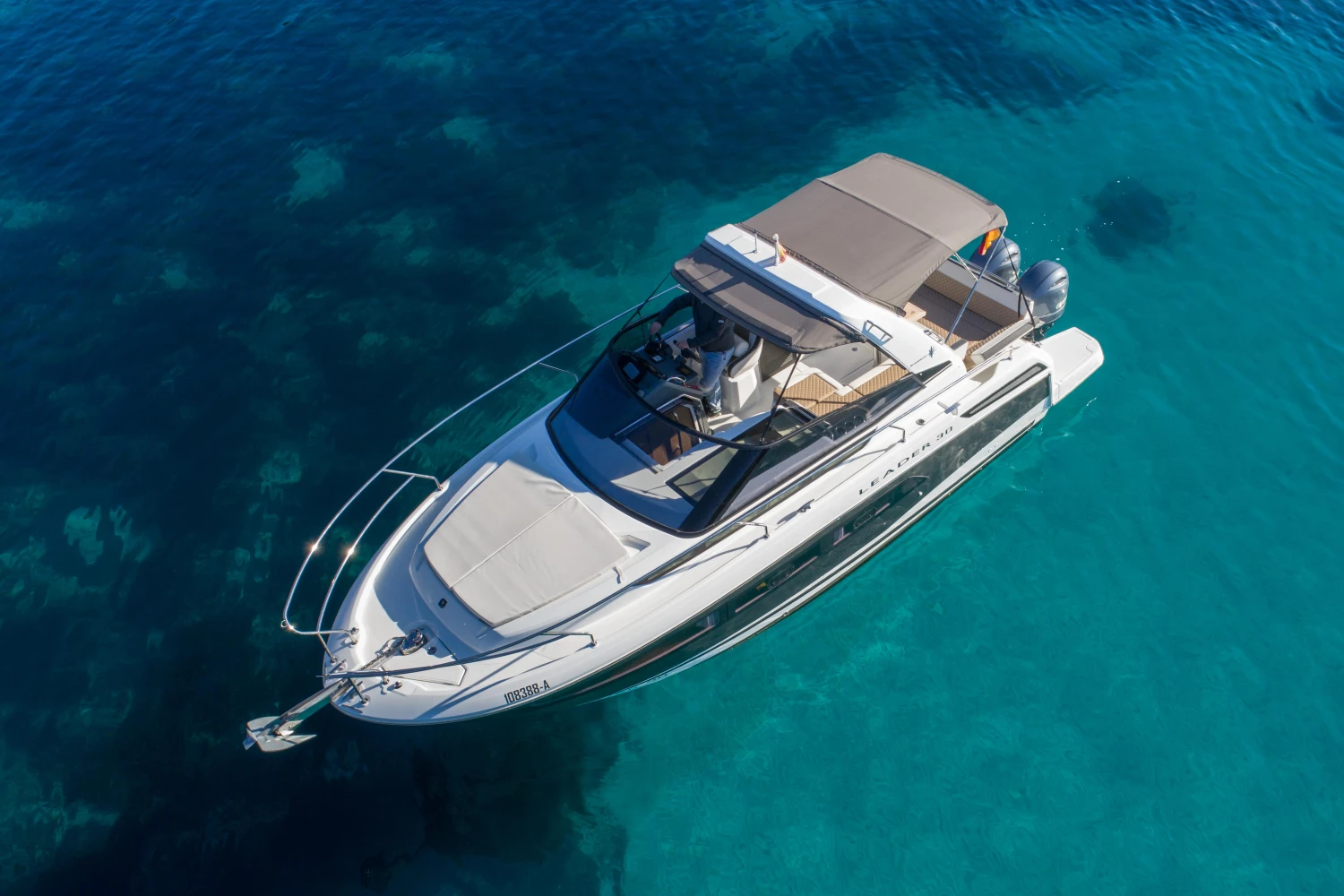 2018 Jeanneau Leader 30 yacht on clear blue water, aerial view.