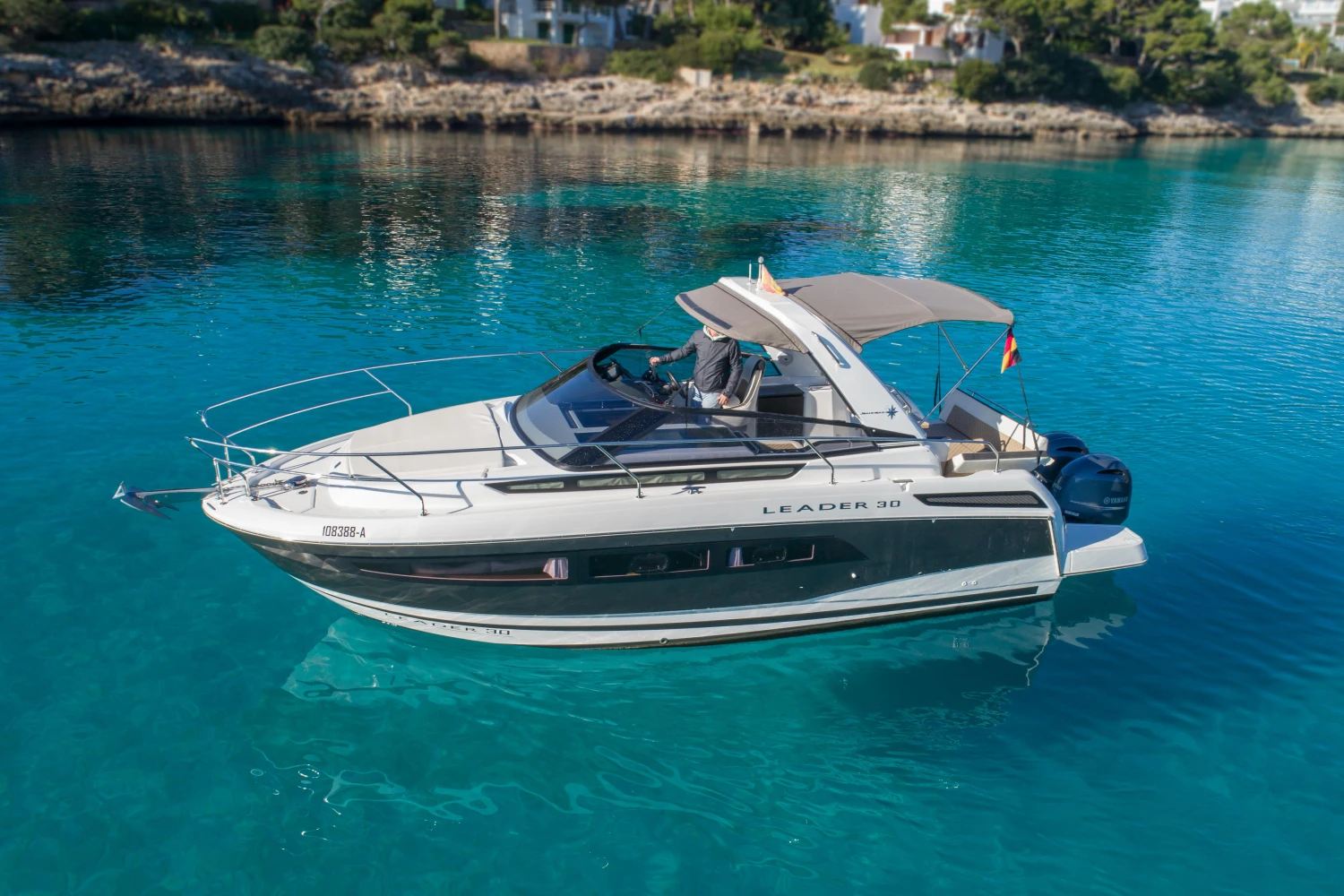 2018 Jeanneau Leader 30 boat on clear blue water, side view.