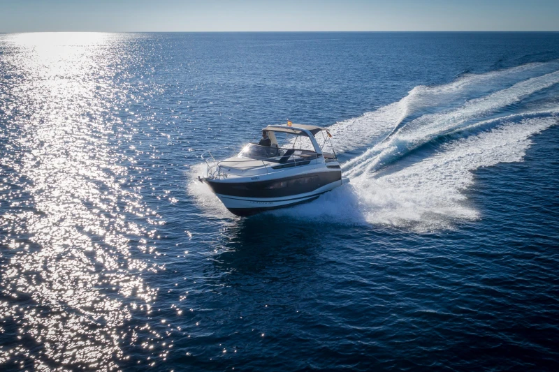 2018 Jeanneau Leader 30 cruising on open sea under clear blue sky.