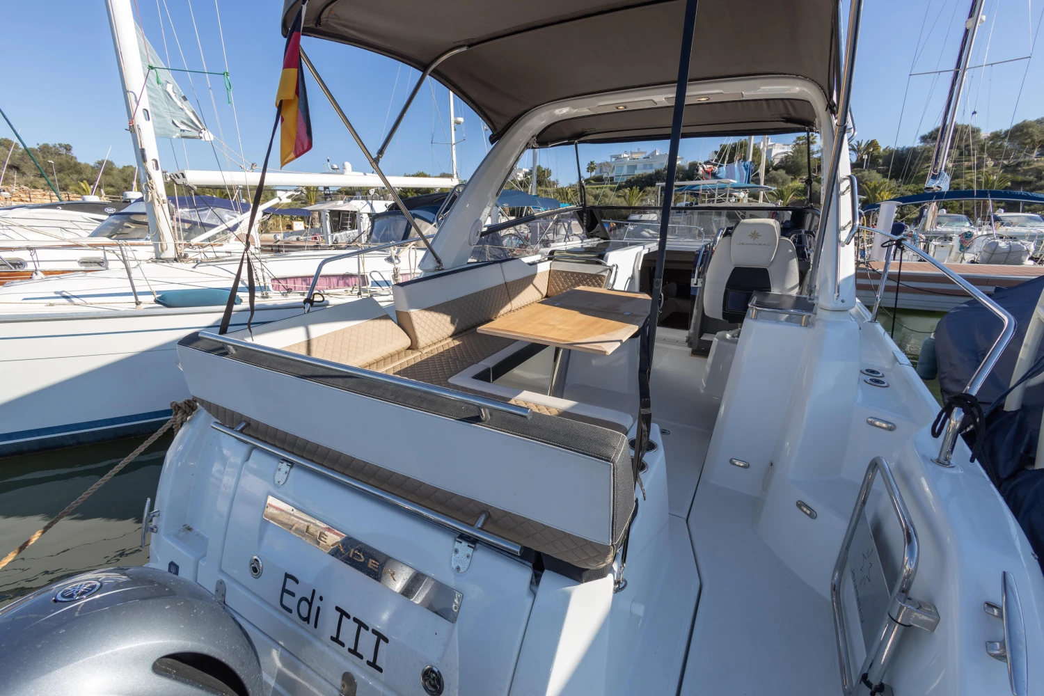 2018 Jeanneau Leader 30 yacht with spacious deck and seating area in marina.