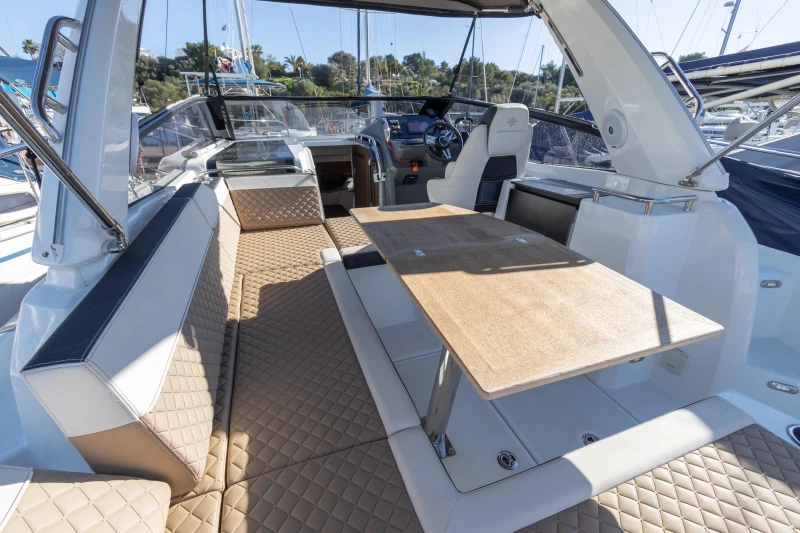 2018 Jeanneau Leader 30 yacht interior with elegant seating and wooden table.