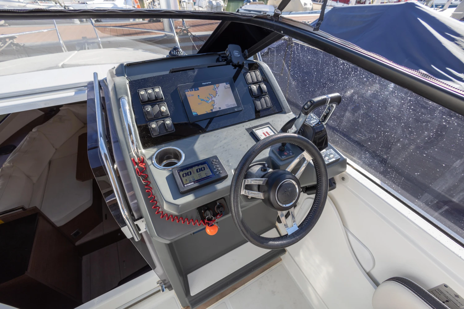 Cockpit of 2018 Jeanneau Leader 30 with navigation controls and steering wheel.