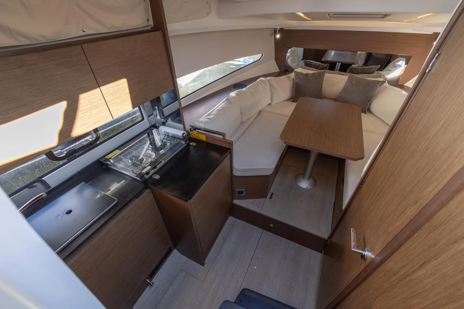 Interior of 2018 Jeanneau Leader 30 yacht with modern kitchen and cozy seating area.