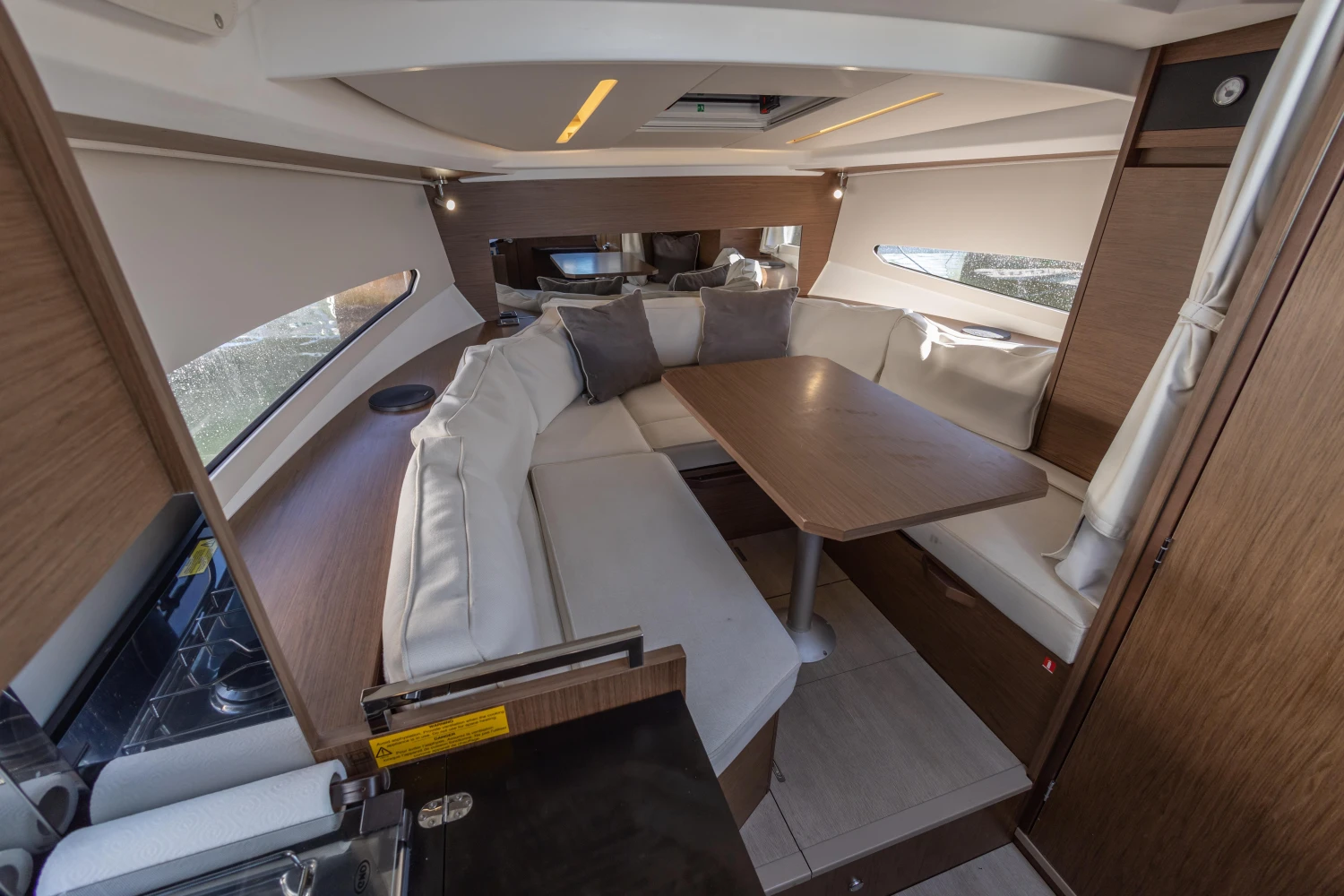 2018 Jeanneau Leader 30 interior with cozy seating and dining area.
