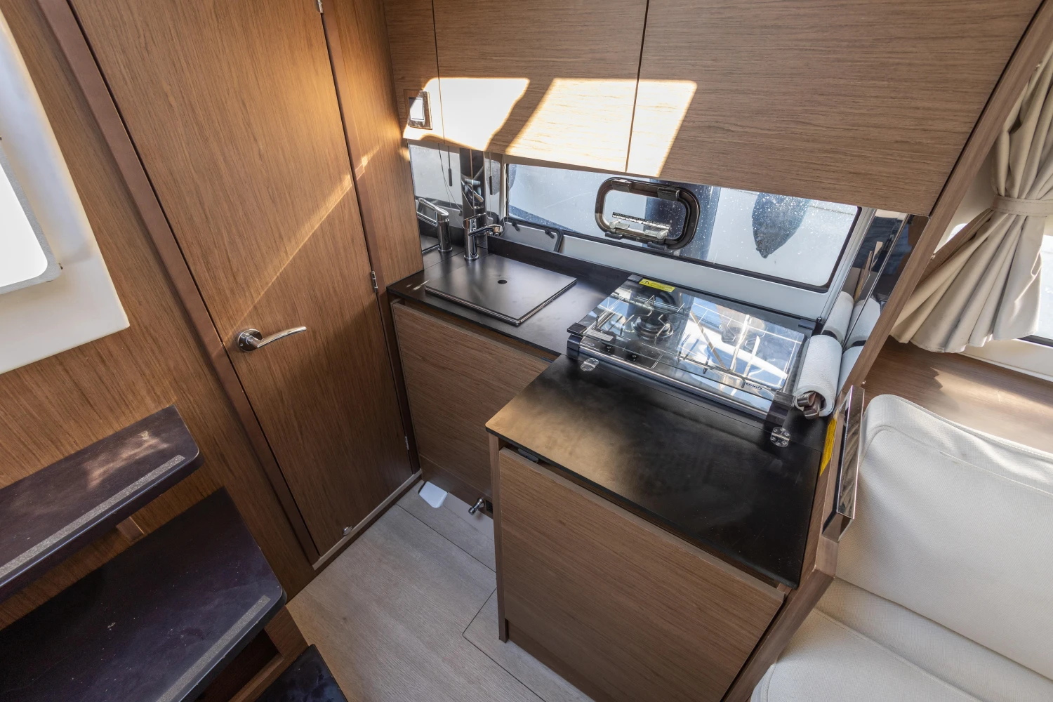 Interior of 2018 Jeanneau Leader 30 yacht, featuring a compact kitchen area.