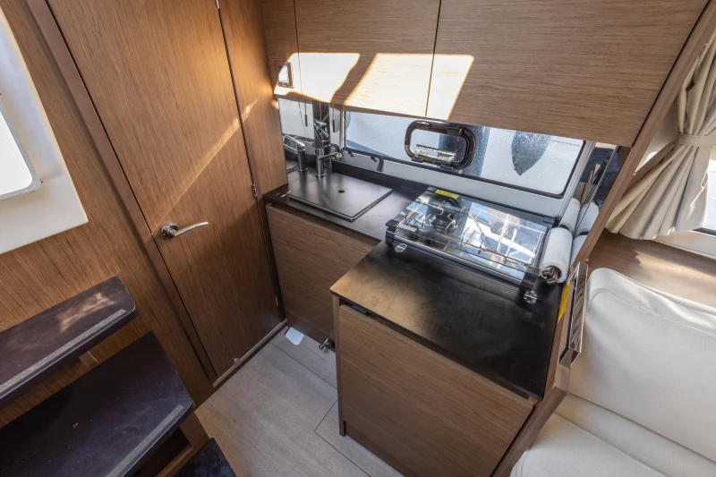 Interior of 2018 Jeanneau Leader 30 yacht, featuring a compact kitchen area.
