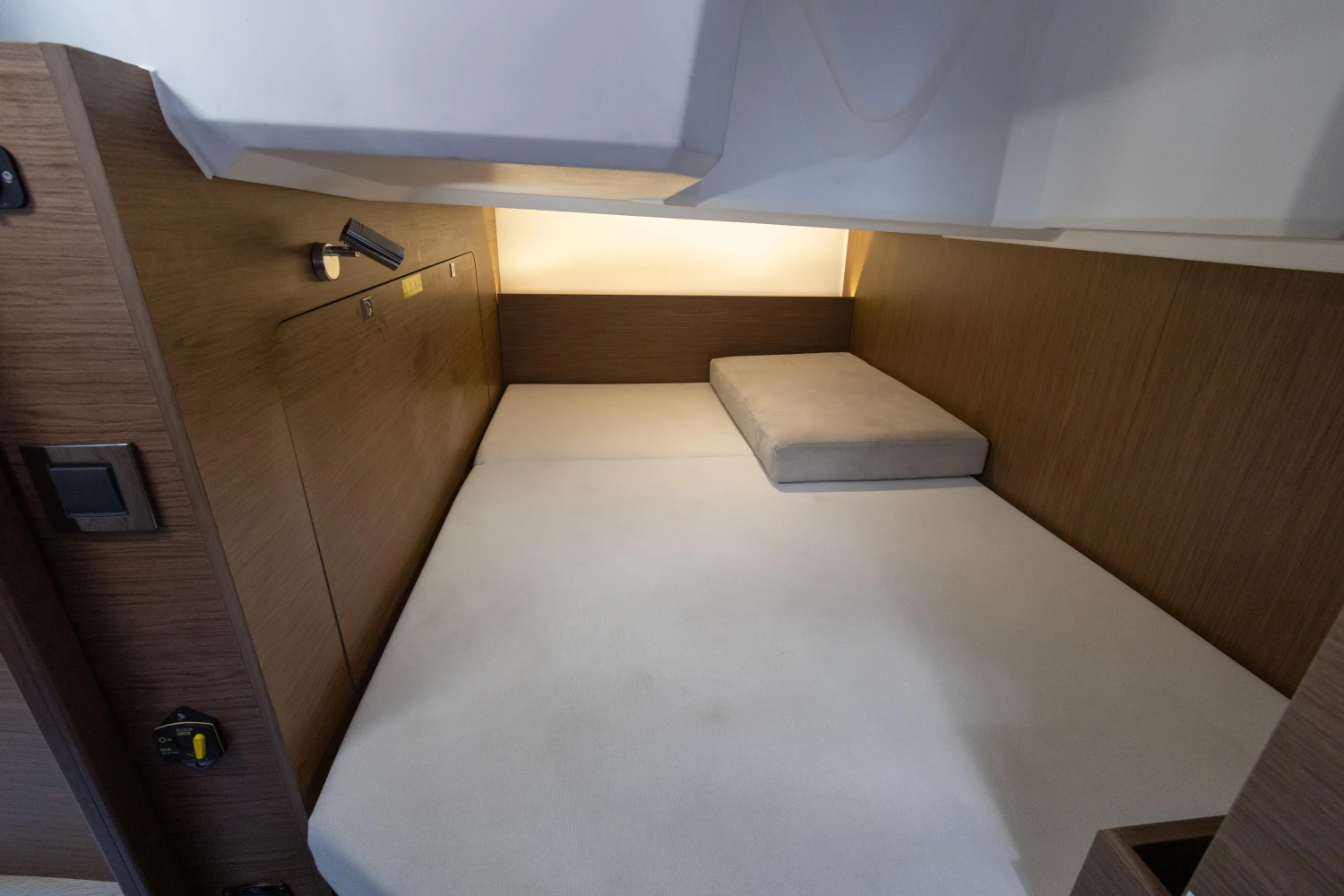 2018 Jeanneau Leader 30 cabin interior with bed and wooden finish.