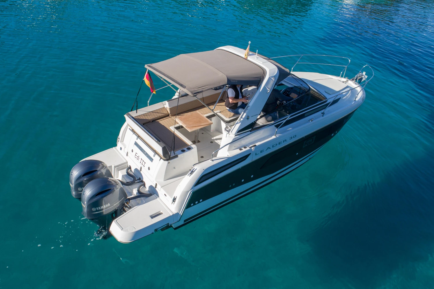 2018 Jeanneau Leader 30 boat cruising on clear blue water.
