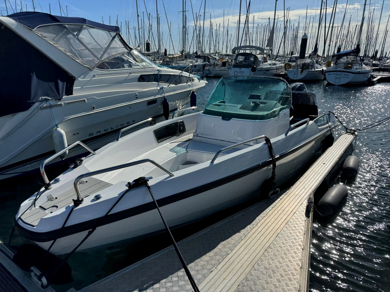 2023 Nordkapp Enduro 705 boat docked in a marina with other vessels.