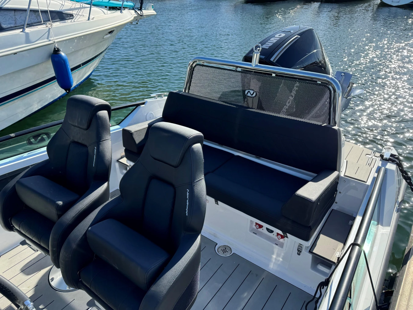 2023 Nordkapp Enduro 705 boat interior with seating and motor, docked on water.