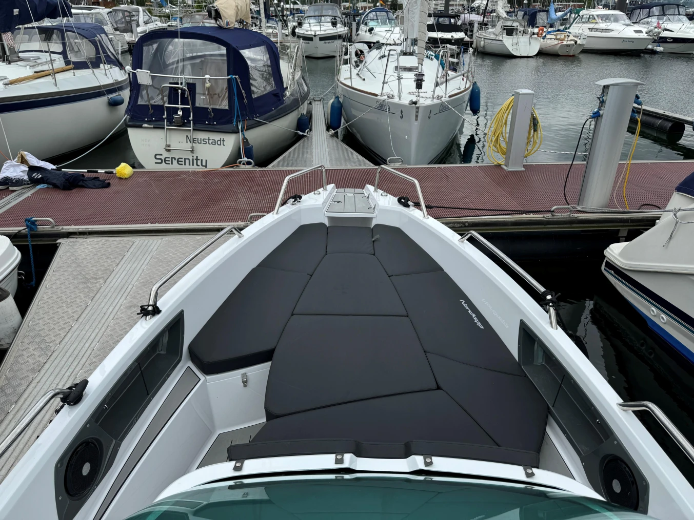 2023 Nordkapp Enduro 705 boat docked at marina, featuring spacious deck and sleek design.