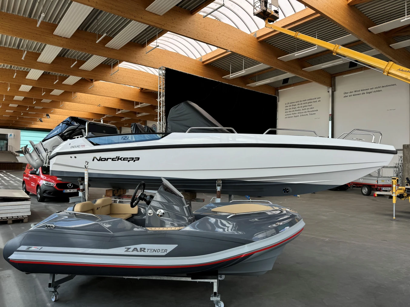 2023 Nordkapp Enduro 705 boat displayed indoors alongside a smaller vessel.