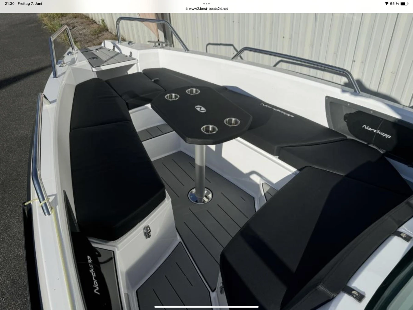 2023 Nordkapp Enduro 705 boat interior with black seating and central table.