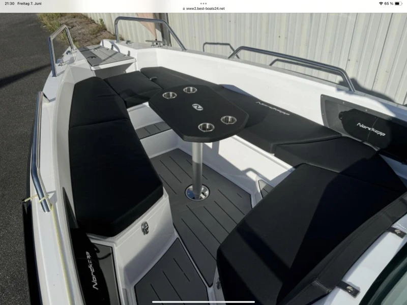 2023 Nordkapp Enduro 705 boat interior with black seating and central table.