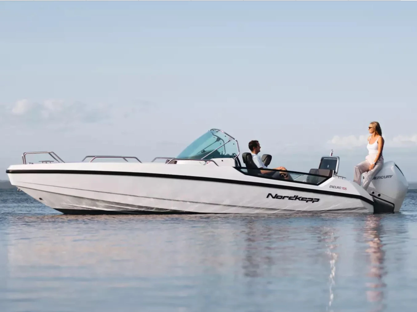 2023 Nordkapp Enduro 705 boat on calm water with two people onboard.