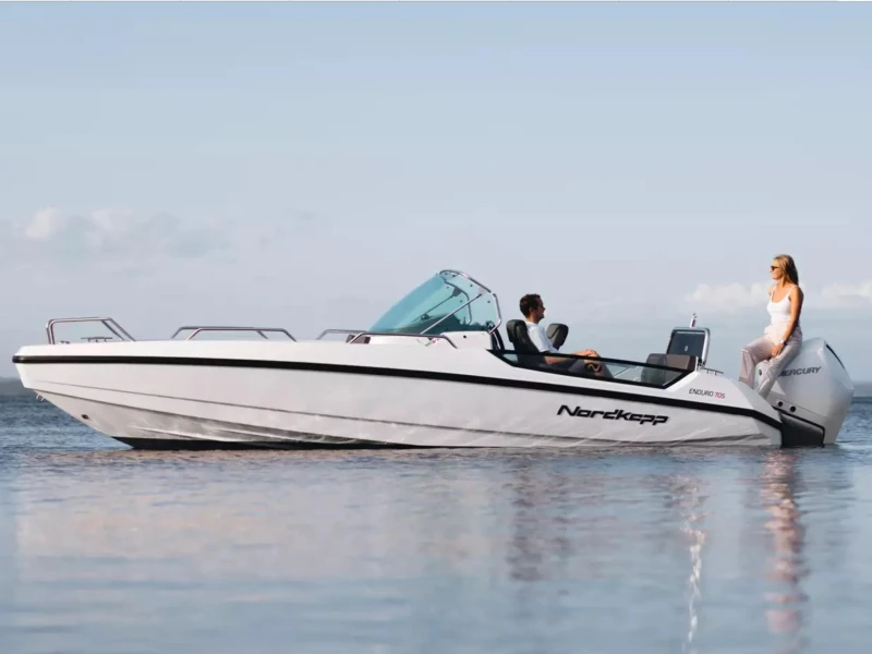2023 Nordkapp Enduro 705 boat on calm water with two people onboard.