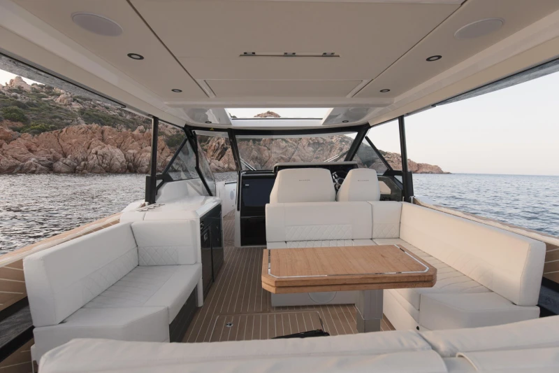 Luxurious interior of 2025 Saxdor 400 GTO yacht with elegant seating and scenic ocean view.