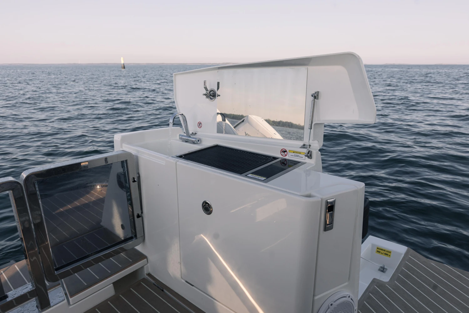 Saxdor 400 GTO 2025 boat deck with grill and ocean view.