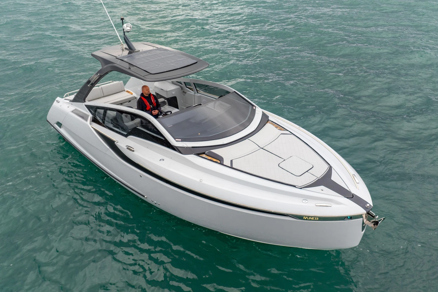 2023 Fairline F//Line 33 luxury yacht cruising on clear blue water.