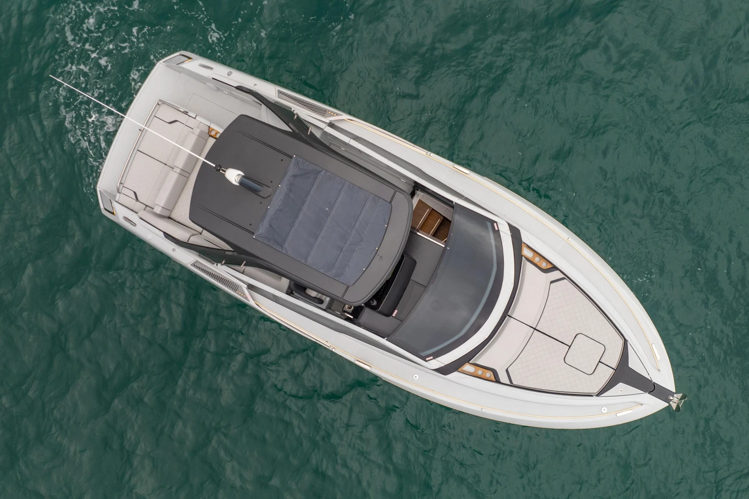 2023 Fairline F//Line 33 luxury yacht, aerial view on turquoise water.