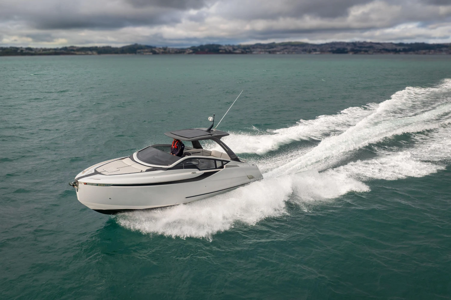 2023 Fairline F//Line 33 yacht cruising on open water under cloudy skies.