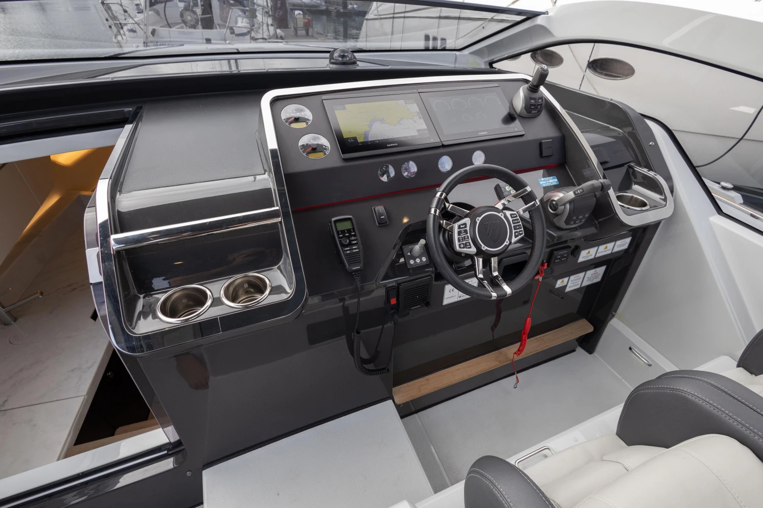 2023 Fairline F//Line 33 yacht cockpit with modern steering and control panel.