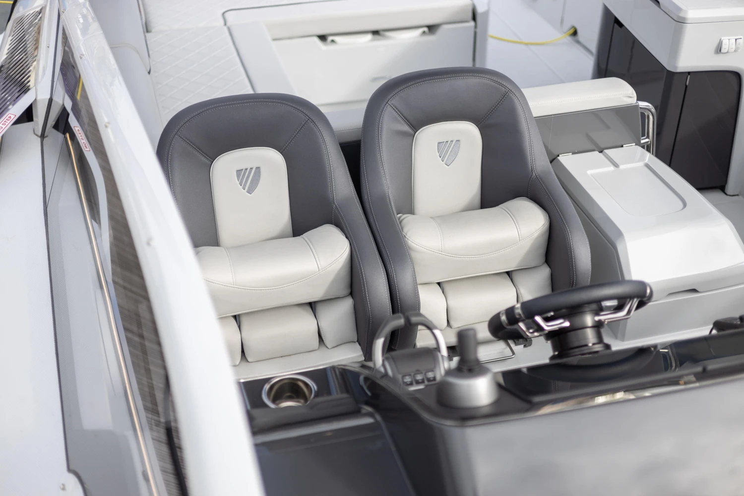 2023 Fairline F//Line 33 cockpit with luxurious seating and modern steering console.