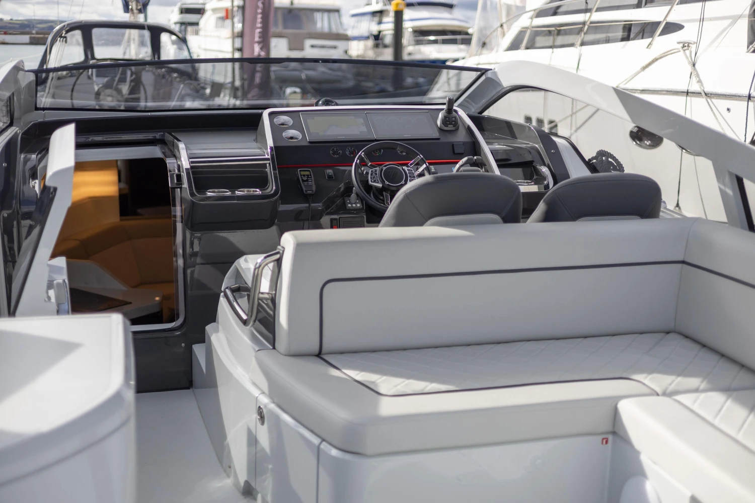 2023 Fairline F//Line 33 yacht interior with sleek seating and modern dashboard.
