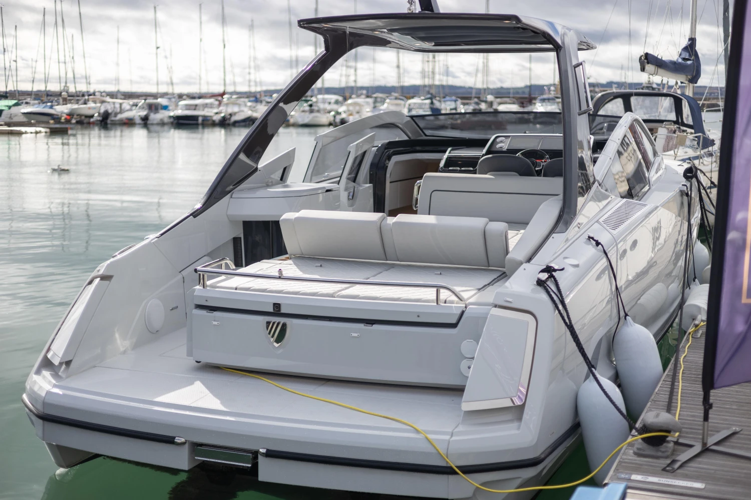 2023 Fairline F//Line 33 luxury yacht docked at marina, rear view.